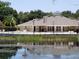 Community clubhouse with pool and lake view at 4768 Walden Cir # 327, Orlando, FL 32811