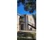 Tan colored siding condo building with a black metal staircase and balcony at 4768 Walden Cir # 327, Orlando, FL 32811
