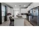 Open concept kitchen with island, stainless steel appliances, and granite countertops at 451 Lasso Dr, Kissimmee, FL 34747