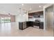 Open concept kitchen with breakfast bar and view into living room at 4523 Cypress Cay Way, Kissimmee, FL 34746