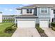 Two-car garage with walkway leading to front door of townhome at 4523 Cypress Cay Way, Kissimmee, FL 34746