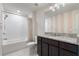 Bathroom boasts granite countertop and tiled shower at 4523 Cypress Cay Way, Kissimmee, FL 34746