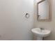 Simple bathroom with pedestal sink and framed mirror at 4523 Cypress Cay Way, Kissimmee, FL 34746
