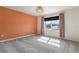 Spacious bedroom with orange accent wall and large window at 4523 Cypress Cay Way, Kissimmee, FL 34746