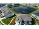 Aerial view of house and community, showcasing a lake and neighborhood amenities at 4523 Cypress Cay Way, Kissimmee, FL 34746