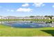 Waterfront view of community with lake reflecting buildings at 4523 Cypress Cay Way, Kissimmee, FL 34746