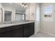 Double vanity bathroom with granite countertop and mirror at 4523 Cypress Cay Way, Kissimmee, FL 34746