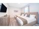 Two twin beds, dresser, and TV in a well-lit guest bedroom at 1157 Challenge Dr # 1157, Davenport, FL 33896