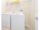 Convenient laundry room with washer and dryer, and overhead shelving at 1157 Challenge Dr # 1157, Davenport, FL 33896