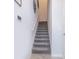Modern carpeted staircase with simple white railing at 1157 Challenge Dr # 1157, Davenport, FL 33896