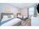 Two twin beds, dresser, and TV in a well-lit guest bedroom at 1157 Challenge Dr # 1157, Davenport, FL 33896