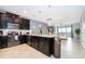 Modern kitchen with dark cabinetry and stainless steel appliances at 1157 Challenge Dr # 1157, Davenport, FL 33896
