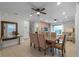 Bright dining room with a large wooden table and access to the living room at 7617 Brookhurst Ln, Kissimmee, FL 34747