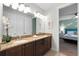 Double vanity bathroom with granite countertop at 7617 Brookhurst Ln, Kissimmee, FL 34747