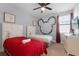 Bedroom with twin beds, Mickey Mouse decor, and TV at 7617 Brookhurst Ln, Kissimmee, FL 34747