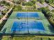 Aerial view of two well-maintained tennis courts in a residential community at 7617 Brookhurst Ln, Kissimmee, FL 34747