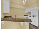 Kitchen with granite countertops and breakfast bar at 4611 Gate Pl # H-203, Orlando, FL 32811