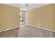 Bright bedroom with large window and neutral carpet at 4611 Gate Pl # H-203, Orlando, FL 32811