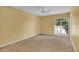 Well-lit bedroom with large window and neutral wall paint at 4611 Gate Pl # H-203, Orlando, FL 32811