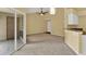 Spacious living room with carpeting and access to patio at 4611 Gate Pl # H-203, Orlando, FL 32811