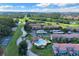 Aerial view of community with pool, tennis courts, and surrounding landscape at 4611 Gate Pl # H-203, Orlando, FL 32811