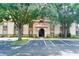 Condo building exterior with parking and landscaping at 4611 Gate Pl # H-203, Orlando, FL 32811