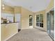 Bright living room with vaulted ceiling and sliding glass doors at 4611 Gate Pl # H-203, Orlando, FL 32811