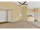 Spacious living room with high ceilings and neutral carpeting at 4611 Gate Pl # H-203, Orlando, FL 32811