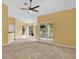 Bright living room featuring sliding glass doors to a balcony at 4611 Gate Pl # H-203, Orlando, FL 32811
