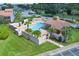 Community pool with a covered patio and lounge chairs at 4611 Gate Pl # H-203, Orlando, FL 32811