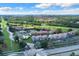Drone view of community, including condos, pool, and tennis courts at 4611 Gate Pl # H-203, Orlando, FL 32811