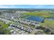 Aerial view of a residential community with lake and green spaces at 2195 Bluebird Pl, St Cloud, FL 34771