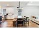 Modern dining area with a long wooden table and black chairs, open to kitchen at 2195 Bluebird Pl, St Cloud, FL 34771