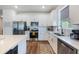 Modern kitchen with white cabinets, stainless steel appliances, and quartz countertops at 2195 Bluebird Pl, St Cloud, FL 34771