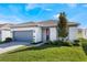 One story home with gray garage door and landscaped lawn at 2195 Bluebird Pl, St Cloud, FL 34771
