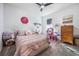 Bedroom with pink bedding, dresser, and dollhouse at 2195 Bluebird Pl, St Cloud, FL 34771