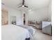 Main bedroom with king bed, grey seating area, and large mirror at 2195 Bluebird Pl, St Cloud, FL 34771