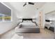 Bright bedroom with a king-size bed and a grey bench at the foot at 2195 Bluebird Pl, St Cloud, FL 34771