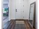 Light and bright entryway with wood-look flooring and a full-length mirror at 2195 Bluebird Pl, St Cloud, FL 34771