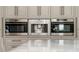 High-end stainless steel appliances including Wolf ovens and a built-in coffee maker at 5126 Fairway Oaks Dr, Windermere, FL 34786