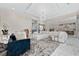 Open living space featuring a white sectional sofa and a view into the kitchen at 5126 Fairway Oaks Dr, Windermere, FL 34786