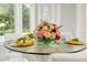 Elegant dining table with a centerpiece and place settings for four at 5126 Fairway Oaks Dr, Windermere, FL 34786
