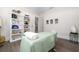 Relaxing massage room with massage table and shelves at 5126 Fairway Oaks Dr, Windermere, FL 34786