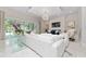 Spacious living room with white sectional sofa, fireplace, and large windows at 5126 Fairway Oaks Dr, Windermere, FL 34786