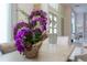 Close-up of a stunning purple orchid centerpiece on a dining room table at 5126 Fairway Oaks Dr, Windermere, FL 34786