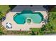 Aerial view of a luxurious, geometric pool and patio area at 5126 Fairway Oaks Dr, Windermere, FL 34786