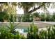 Landscaped pool area with decorative pots and lush greenery at 5126 Fairway Oaks Dr, Windermere, FL 34786