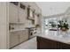 Modern kitchen with white cabinets, marble countertops, and a large island at 5126 Fairway Oaks Dr, Windermere, FL 34786