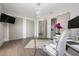 Bright home office with glass desk and hardwood floors at 5126 Fairway Oaks Dr, Windermere, FL 34786