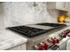 Stainless steel gas cooktop with red control knobs and marble countertop at 5126 Fairway Oaks Dr, Windermere, FL 34786